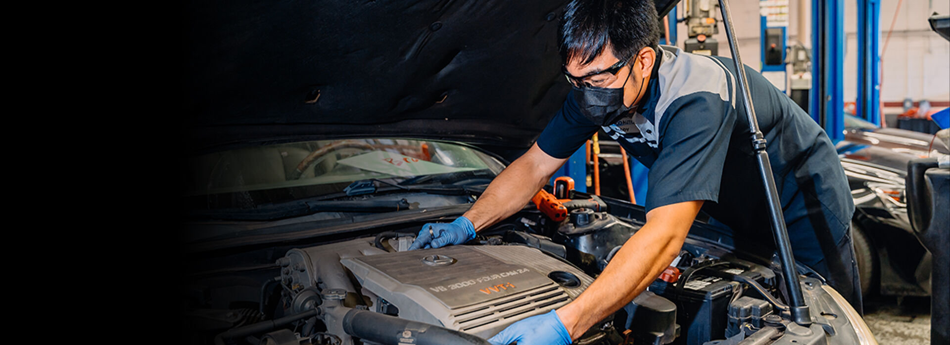 Service technician working on a Lexus vehicle.