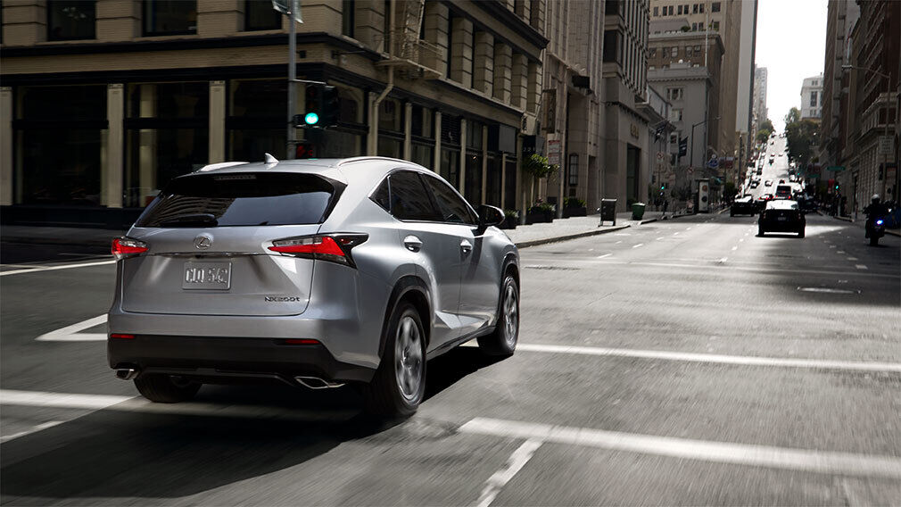 Lexus RX crossing an intersection in the city.