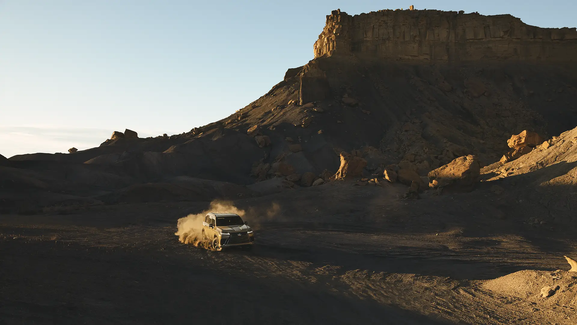 LX Ultra Luxury shown in Manganese Luster driving through a desert