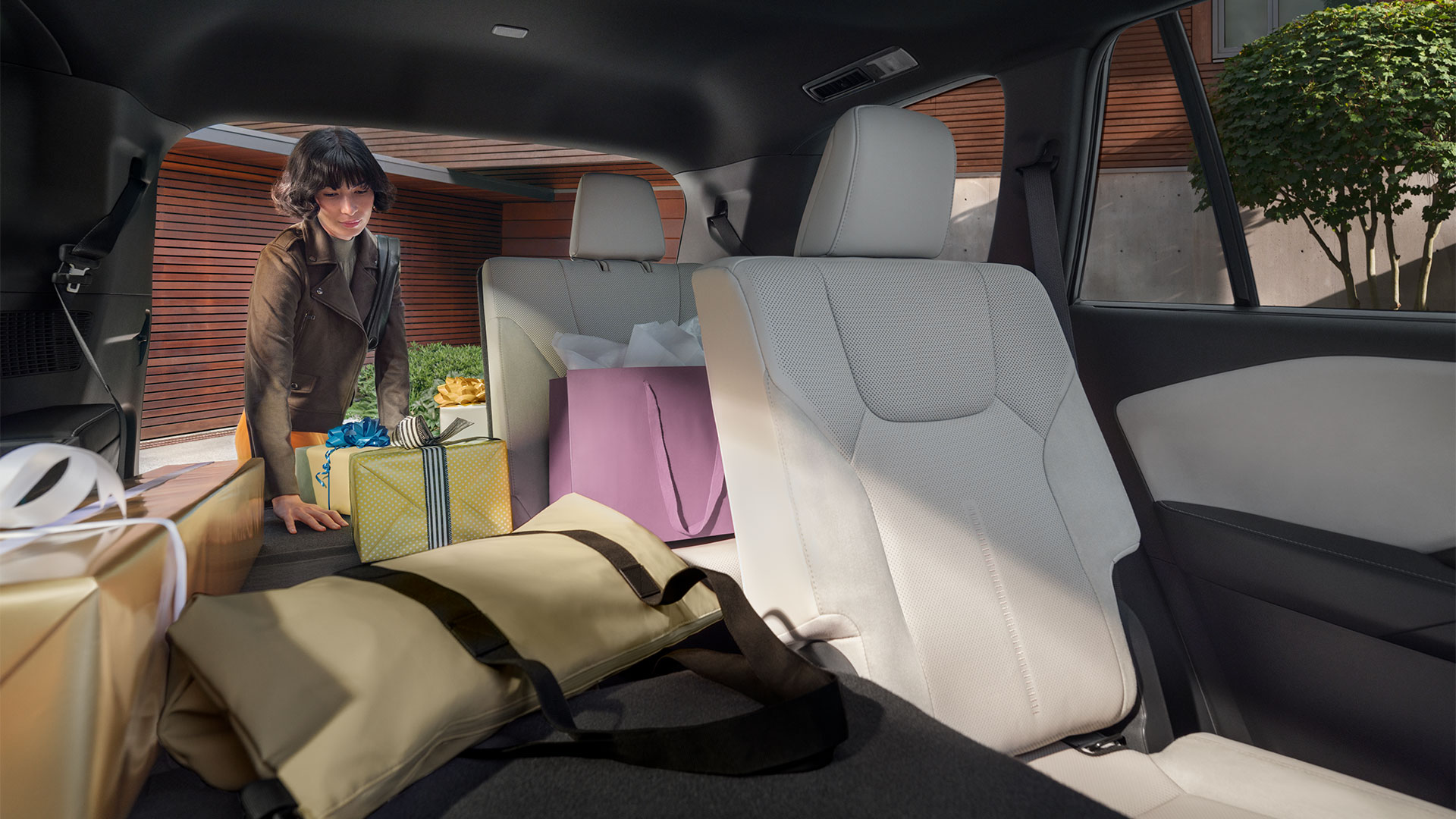 Talent loading vehicle from the trunk with the 3rd and 2nd row  seats folded down.