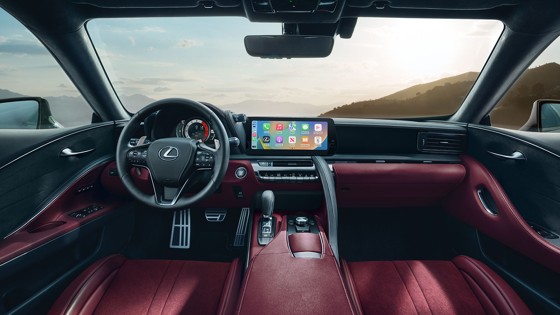 Steering wheel, console, touchscreen, and front seats.