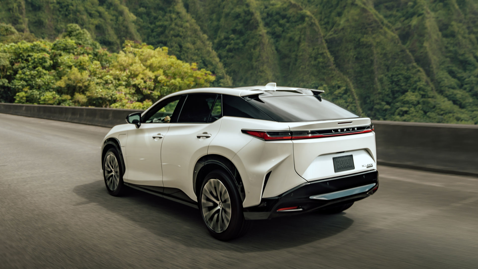 RZ driving away from camera showing rear cat ear roof and unified LED taillights