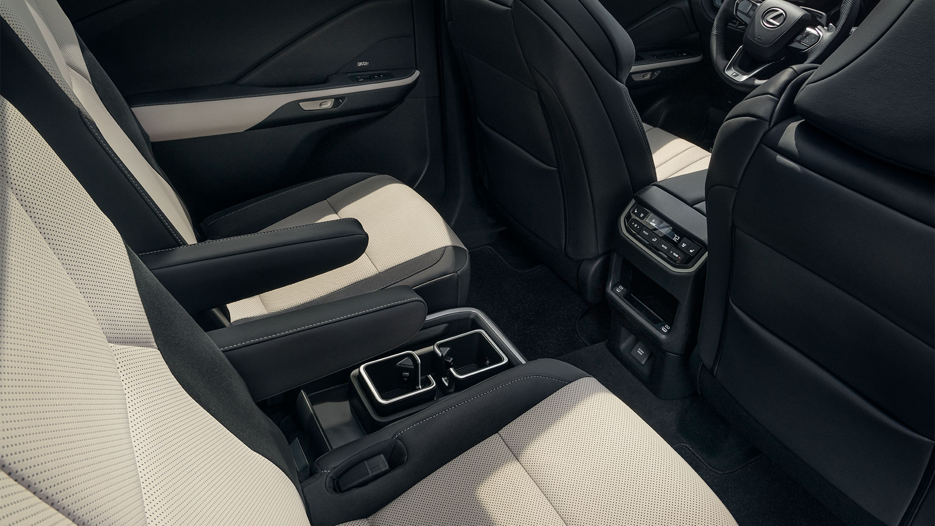 Rear console and seats of the 2025 Lexus TX 500 Hybrid with Birch leather-trimmed seats and Black Grained trim (Luxury)