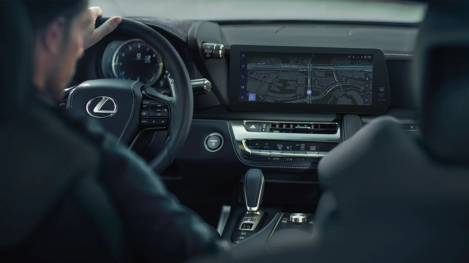 Steering wheel, console, touchscreen, and front seats.
