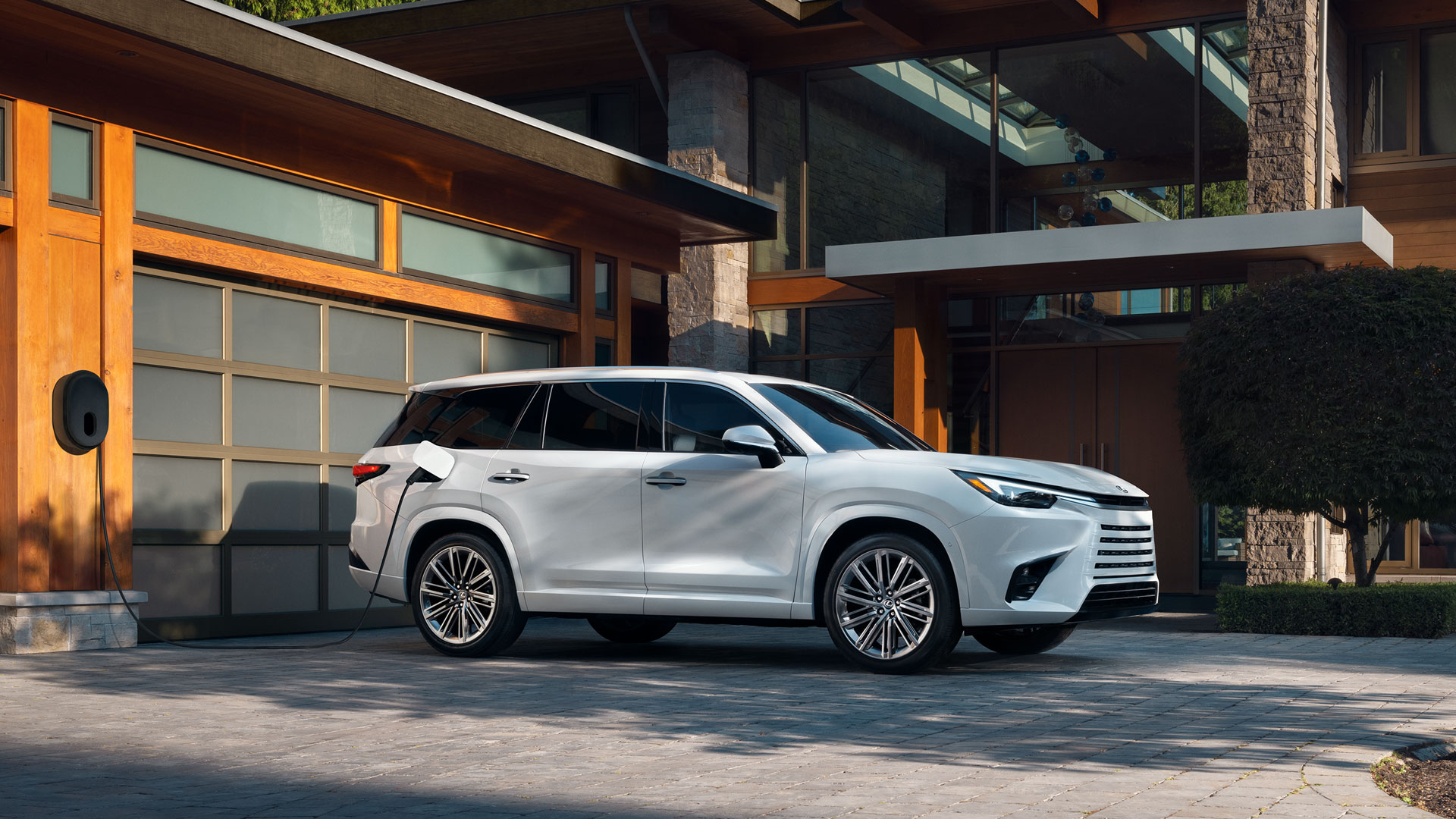 2025 Lexus TX 500 Hybrid Wind Chill Pearl plugged in to charge